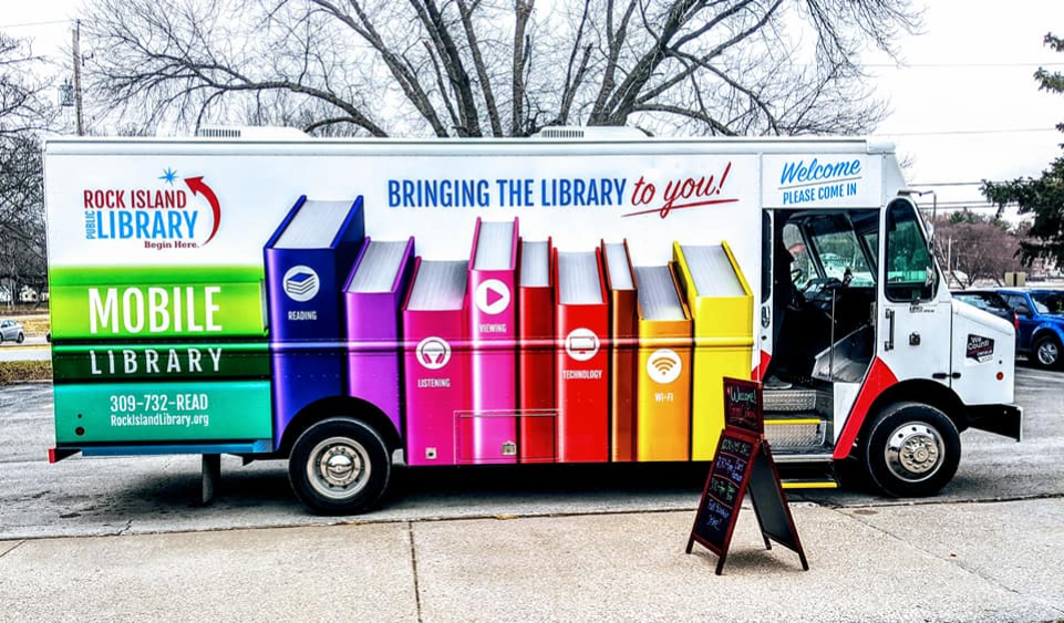 Mobile library vehicle parked on street.